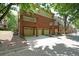Townhome exterior with brick facade, garages and balconies on a tree-lined street at 718 Province Se Pl, Atlanta, GA 30312