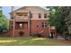 Back view of house showing brick facade, balconies, and large green lawn at 718 Province Se Pl, Atlanta, GA 30312