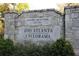 Park signage reading 'Zoo Atlanta Cyclorama' on a stone entrance with bushes at the bottom at 718 Province Se Pl, Atlanta, GA 30312