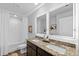 Modern bathroom featuring dual sinks, granite countertops, illuminated mirrors, and a shower-tub combination at 192 Weldon Rd, Mcdonough, GA 30253