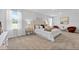 Spacious bedroom boasts neutral decor, plush carpet, and abundant natural light from large windows at 192 Weldon Rd, Mcdonough, GA 30253