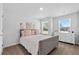 Bright bedroom featuring a large window, plush carpet, and stylish white furniture with pink accents at 192 Weldon Rd, Mcdonough, GA 30253