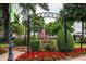 McDonough town square with an American flag surrounded by red flowers and lush greenery under a cloudy sky at 192 Weldon Rd, Mcdonough, GA 30253