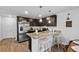 Modern kitchen with stainless steel appliances, granite countertops, and dark cabinets with seating at the counter at 192 Weldon Rd, Mcdonough, GA 30253