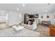 Open-concept living room with hardwood floors, a white couch with accent pillows, and a view of the kitchen at 192 Weldon Rd, Mcdonough, GA 30253