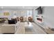 Bright living room featuring hardwood floors, a white couch, chairs, and a modern electric fireplace at 192 Weldon Rd, Mcdonough, GA 30253