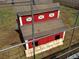 Rustic red rabbit hutch named 