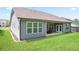 This backyard features a covered patio and well-manicured lawn, ideal for outdoor gatherings at 3322 Grace Farm Ln, Buford, GA 30519