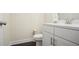 Modern half-bath features a stylish white vanity, sleek fixtures, and convenient toilet at 3322 Grace Farm Ln, Buford, GA 30519