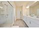 Elegant bathroom featuring a glass-enclosed shower, double vanity, and modern fixtures at 3322 Grace Farm Ln, Buford, GA 30519
