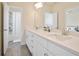 Bright bathroom featuring double sinks, white cabinetry, and a shower-tub combination for convenience at 3322 Grace Farm Ln, Buford, GA 30519