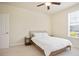 Well-lit bedroom with a ceiling fan and window, providing a relaxing and inviting space at 3322 Grace Farm Ln, Buford, GA 30519