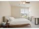 Cozy bedroom with a ceiling fan and window, offering natural light and a comfortable atmosphere at 3322 Grace Farm Ln, Buford, GA 30519