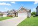 Well-kept home with a driveway, green lawn, and tasteful landscaping at 3322 Grace Farm Ln, Buford, GA 30519