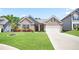 Charming brick home with lush green lawn, manicured landscaping, and a two-car garage at 3322 Grace Farm Ln, Buford, GA 30519