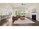 Spacious living room with hardwood floors, fireplace, and ample natural light at 3322 Grace Farm Ln, Buford, GA 30519