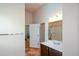 This bathroom features a dark vanity, tile floors, and a combined tub and shower at 6816 Diamond Dr, Rex, GA 30273