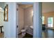 This powder room features a toilet, sink, and decorative mirror at 6816 Diamond Dr, Rex, GA 30273
