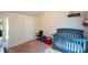 This Bedroom features a gray crib, plush carpet, and vaulted ceilings at 6816 Diamond Dr, Rex, GA 30273