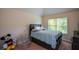 This cozy bedroom features plush carpet, neutral walls, and a window with natural light at 6816 Diamond Dr, Rex, GA 30273