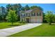 Charming two-story home with a well-manicured lawn, a two-car garage, and a classic architectural design at 6816 Diamond Dr, Rex, GA 30273