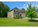 Charming two-story home with a well-manicured lawn, two car garage, and welcoming entrance at 6816 Diamond Dr, Rex, GA 30273