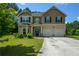 Charming two-story home with a manicured lawn and a two-car garage at 6816 Diamond Dr, Rex, GA 30273