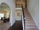 Inviting foyer with high ceilings, an elegant staircase, and arched doorways leading to the dining room at 6816 Diamond Dr, Rex, GA 30273