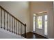 The foyer features hardwood floors, a staircase with iron spindles, and a window-lined front door at 6816 Diamond Dr, Rex, GA 30273
