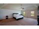Spacious primary bedroom with neutral tones, large windows, and a ceiling fan at 6816 Diamond Dr, Rex, GA 30273