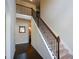 A staircase with wooden handrails and decorative iron balusters leads to the upper level at 6816 Diamond Dr, Rex, GA 30273