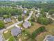 An aerial view of a home surrounded by a well-manicured lawn and mature trees and in a quiet neighborhood at 1032 Jordan Rd, Dacula, GA 30019