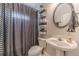 Nicely renovated bathroom with modern fixtures, decorative shelving and chevron shower curtain at 1032 Jordan Rd, Dacula, GA 30019