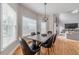 Dining area with table set for six, natural light, and views of the living room and fireplace at 1032 Jordan Rd, Dacula, GA 30019