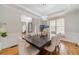 Bright dining room with hardwood floors, wainscoting, and an elegant chandelier above the large dining table at 1032 Jordan Rd, Dacula, GA 30019