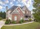 Beautiful two-story home featuring brick and siding, a well-maintained lawn, and a side-entry garage at 1032 Jordan Rd, Dacula, GA 30019