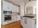 Bright kitchen with white cabinets, stainless steel appliances and hardwood floors at 1032 Jordan Rd, Dacula, GA 30019