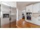 Spacious kitchen with stainless steel appliances, white cabinets, and hardwood flooring at 1032 Jordan Rd, Dacula, GA 30019