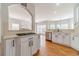 Open kitchen with white cabinets, stainless steel appliances, and breakfast bar overlooking the living area at 1032 Jordan Rd, Dacula, GA 30019