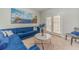 Elegant living room featuring a plush blue sofa, marble coffee table, and view of French doors to the patio at 1032 Jordan Rd, Dacula, GA 30019
