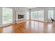 Bright living room with a fireplace, hardwood floors and lots of natural light at 1032 Jordan Rd, Dacula, GA 30019