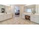 Bright main bathroom featuring dual vanity, white cabinets and a tiled floor at 1032 Jordan Rd, Dacula, GA 30019