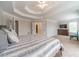 Relaxing main bedroom featuring a tray ceiling, carpet floors, and large windows at 1032 Jordan Rd, Dacula, GA 30019