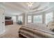 Comfortable main bedroom with a tray ceiling, plush carpets, and generous natural light from multiple windows at 1032 Jordan Rd, Dacula, GA 30019