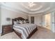Spacious main bedroom featuring a tray ceiling, a large bed, and ensuite access at 1032 Jordan Rd, Dacula, GA 30019