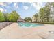 A bright community pool on a sunny day with ample deck space and a shaded cabana at 1032 Jordan Rd, Dacula, GA 30019