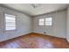 Bedroom featuring hardwood floors, with natural light from the two windows at 118 Ingleside Dr, Jonesboro, GA 30236