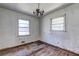 Image shows a bedroom featuring a light fixture, wood flooring, and natural light at 118 Ingleside Dr, Jonesboro, GA 30236