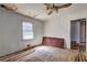 Bedroom needs TLC, featuring damaged walls, floors and outdated ceiling fan at 118 Ingleside Dr, Jonesboro, GA 30236