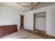 Bedroom with peeling paint and worn floors, showing a closet and doorway at 118 Ingleside Dr, Jonesboro, GA 30236